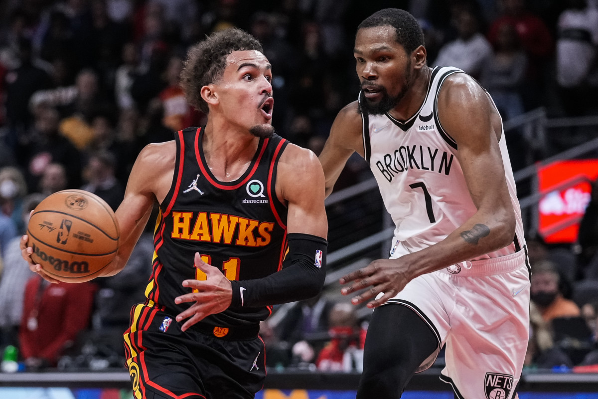 Atlanta Hawks guard Trae Young (11) tries to get to the basket guarded by Brooklyn Nets forward Kevin Durant (7) during the second half at State Farm Arena.